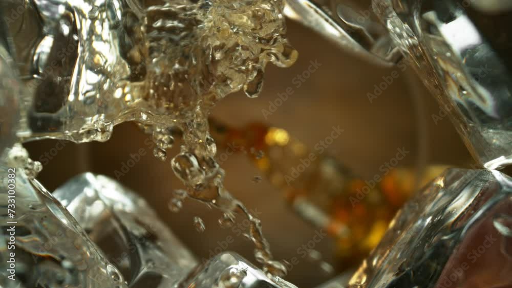 Poster super slow motion of pouring whiskey into glass. unique perspective composition from bottom of the g