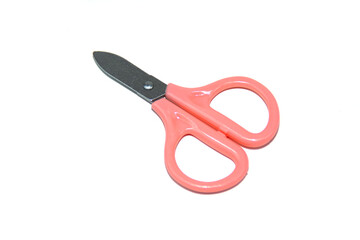 Small children's pink scissors isolated on white.