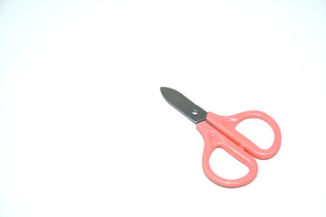 Small children's pink scissors isolated on white.