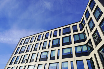 Look up to white building facade towards blue sky. Kopli, Tallinn, Estonia. February 2024