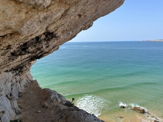 Natural rock at the ocean, azure water of the ocean, sandstone texture 
