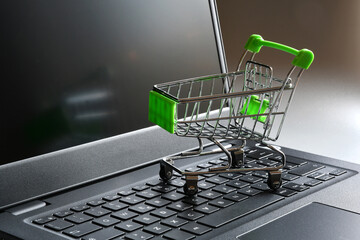 Shopping online. Shopping cart on a laptop keyboard. Concept for online shopping.