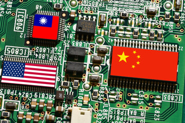Flag of the Republic of China, United States and Taiwan on microchips of a printed electronic board. Concept for world supremacy in microchip and semiconductor manufacturing.