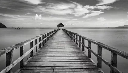 Fototapeten old wooden bridge or pier to the sea in black and white thailand © Richard