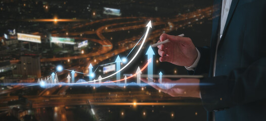 financial investment strategy chart growth arrow achievement diagram of finance marketing graph on blurred city night background with businessman using tablet working with graph