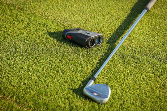 Golf , green grass, binoculars for golf observing, Laser Rangefinder, golfer stick. - Powered by Adobe