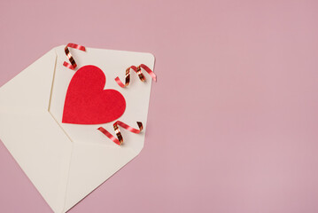 White Paper Envelopes with red and pink heart for valentine day on pink background Copy space horizontal