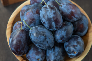 Plum variety Hungarian. Fruit harvest on the table in the kitchen. Autumn blue plum. Vitamin food bowl.