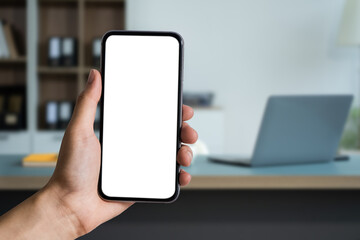 Business - technology and office concept - Hand holding mobile phone with blank screen in office.