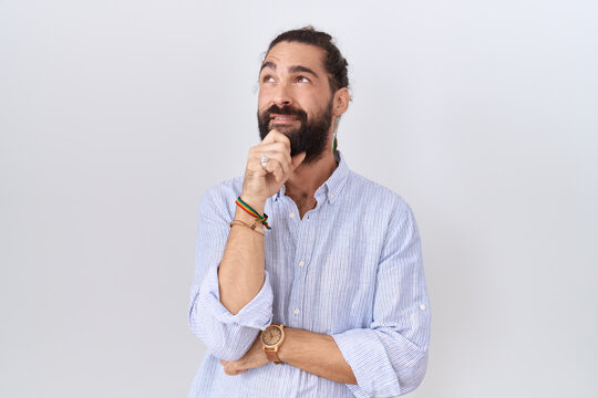 Hispanic man with beard wearing casual shirt thinking worried about a question, concerned and nervous with hand on chin
