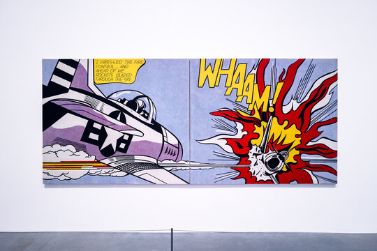London, UK - December 10 2022 : Tate Modern art gallery museum, Roy Lichtenstein WHAM, famous pop art painting of aeroplane and explosion on gallery wall with concrete floor