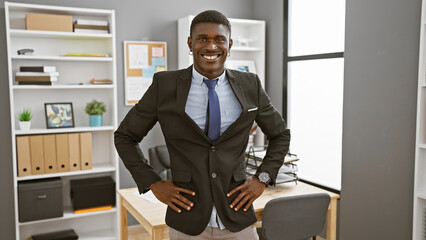 Confident man in suit standing in modern office, smiling at the camera