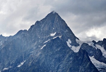 Fototapeta na wymiar the cloudy summit of Grandes Jorasses, italian alps, Tour du Mont Blanc
