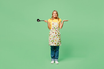 Full body young sad confused housewife housekeeper chef cook baker woman wear apron yellow t-shirt...