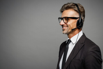 Close up adult employee operator business man wears black suit set microphone headset for helpline...