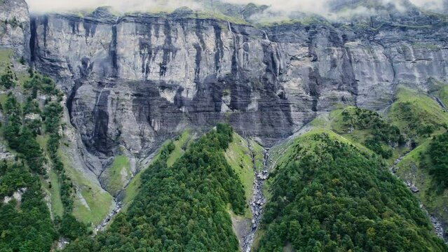 Giffre valley of mountain range with cascade and foggy in French Alps borderland at France