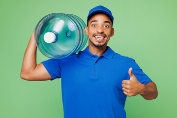 Professional delivery guy employee man wear blue cap t-shirt uniform workwear work as dealer courier hold big large clear water bottle show thumb up isolated on plain green background Service concept