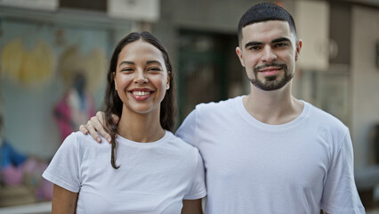 Fototapeta premium Gorgeous couple, full of love & confidence, embrace in a happy hug on the sunny city street