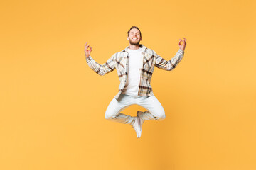 Fototapeta na wymiar Full body spiritual young Caucasian man in brown shirt casual clothes jump high hold spreading hands in yoga om aum gesture relax meditate try to calm down isolated on plain yellow orange background