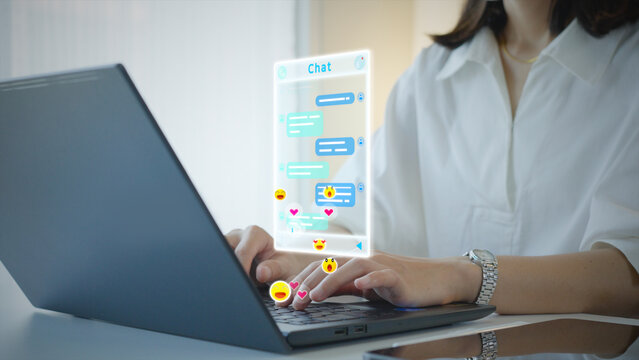 Woman using computer type text conversation chat online social media send feelings like love smile laugh heart emoji icons interactive.