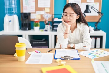 Young chinese woman business worker tired working at office