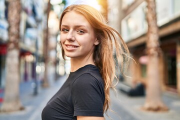 Fototapeta premium Young blonde woman smiling confident standing at street