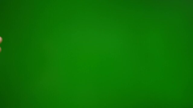 Fingers grab and raise on a green background.