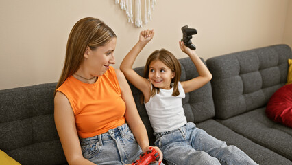 A woman and girl enjoy a video game in their modern living room, reflecting family, togetherness, and leisure.