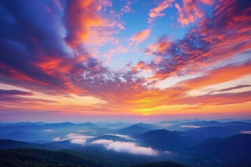 Obraz premium Majestic sunrise or sunset landscape with stunning nature's light and rolling colorful clouds.