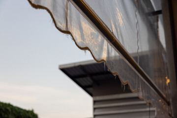 transparent plastic awning of outdoor shop. plastic rain cover of house.