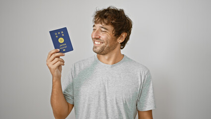 Confident young hispanic man grinning broadly, holding his japanese passport, isolated on white...