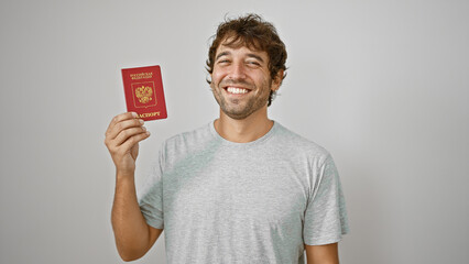 Beaming blond young man, patriot of russia, holds passport with confidence over white isolated...