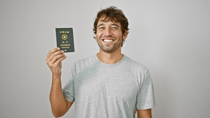 Jovial young man, with twinkling eyes, flaunts his taiwanese passport. standing solo against a...