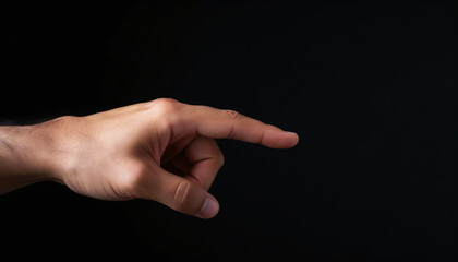 Human male hand with index finger outstretched. Hand and finger touchscreen gesture tap, touch, point. Pointing or tapping something. Isolated object in front of a black background. From the side.