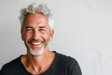 Obraz premium Closeup portrait of Handsome smiling mature man isolated on white background