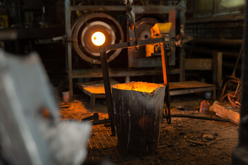 Foundry ladle with molten metal in workshop of metallurgical plant