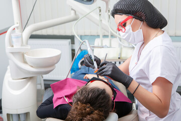 Young Female patient with pretty smile examining dental inspection at dentist clinic. Healthy teeth...