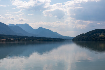 Idyllic river Drava with with scenic view of untamed mountain peaks of Karawanks, Feistritz im Rosental, Carinthia, Austria. Looking at majestic Mittagskogel summit in summer. Hiking in Austrian Alps