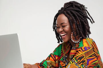 Portrait of a happy young African woman using laptop computer.
