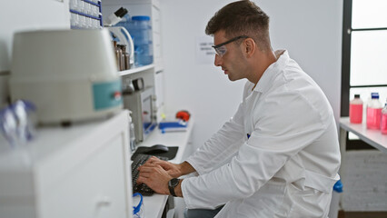 Attractive young hispanic man, a diligent scientist, immersed in profound medical research on his computer in the bustling laboratory