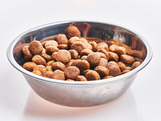  Delicious bowl of dog food balls over isolated white background