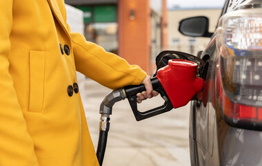 woman filling gas in a SUV