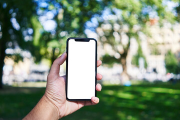 Man holding smartphone showing white blank screen at park