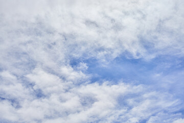 A tranquil image capturing soft white clouds against a serene blue sky, symbolizing peace and tranquility in nature.