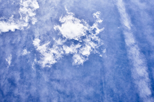 Vivid sky with fluffy cumulus clouds against a blue background suitable for weather or nature themes.