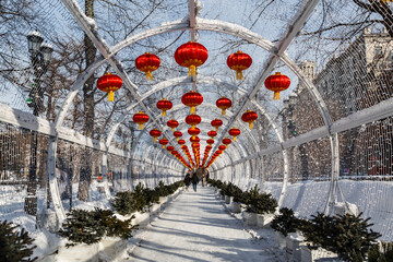 Chinese New Year in Moscow. Decorative tunnel with red decorative lanterns on Tverskoy Boulevard - 733188587
