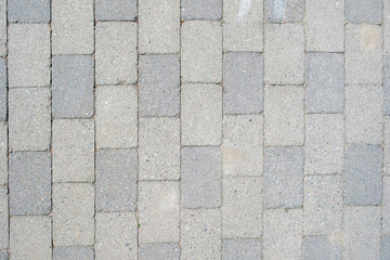 Empty cobblestone grey stone sidewalk background texture. Paved floor backdrop. Above, copy space