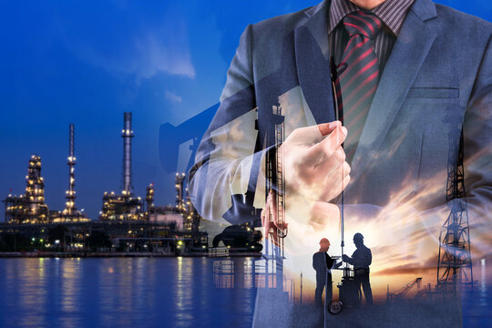 Double exposure of businessman with refinery plant and Crude Oil pump oil rig energy industrial machine for petroleum background