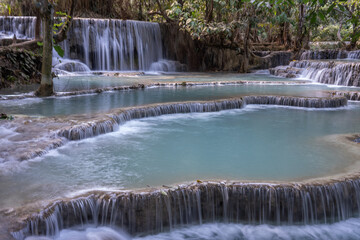 The Kuang Si Waterfall is located 30 km to the south of Luang Prabang in the Southeast Asian country of Laos.