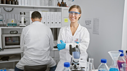 Two amiable scientists, best mates, sitting with arms crossed, engrossed in serious lab work in a...